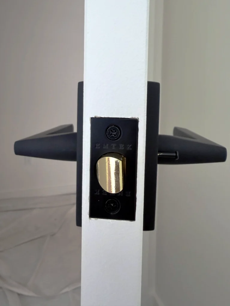 Interior door hardware installed in a newly finished door showcasing perfect mortising for the latch plate